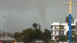 Freak tornado rips through City beach uprooting powerlines and trees 