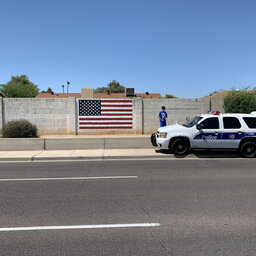 Phoenix police officers repaint vandalized American flag mural
