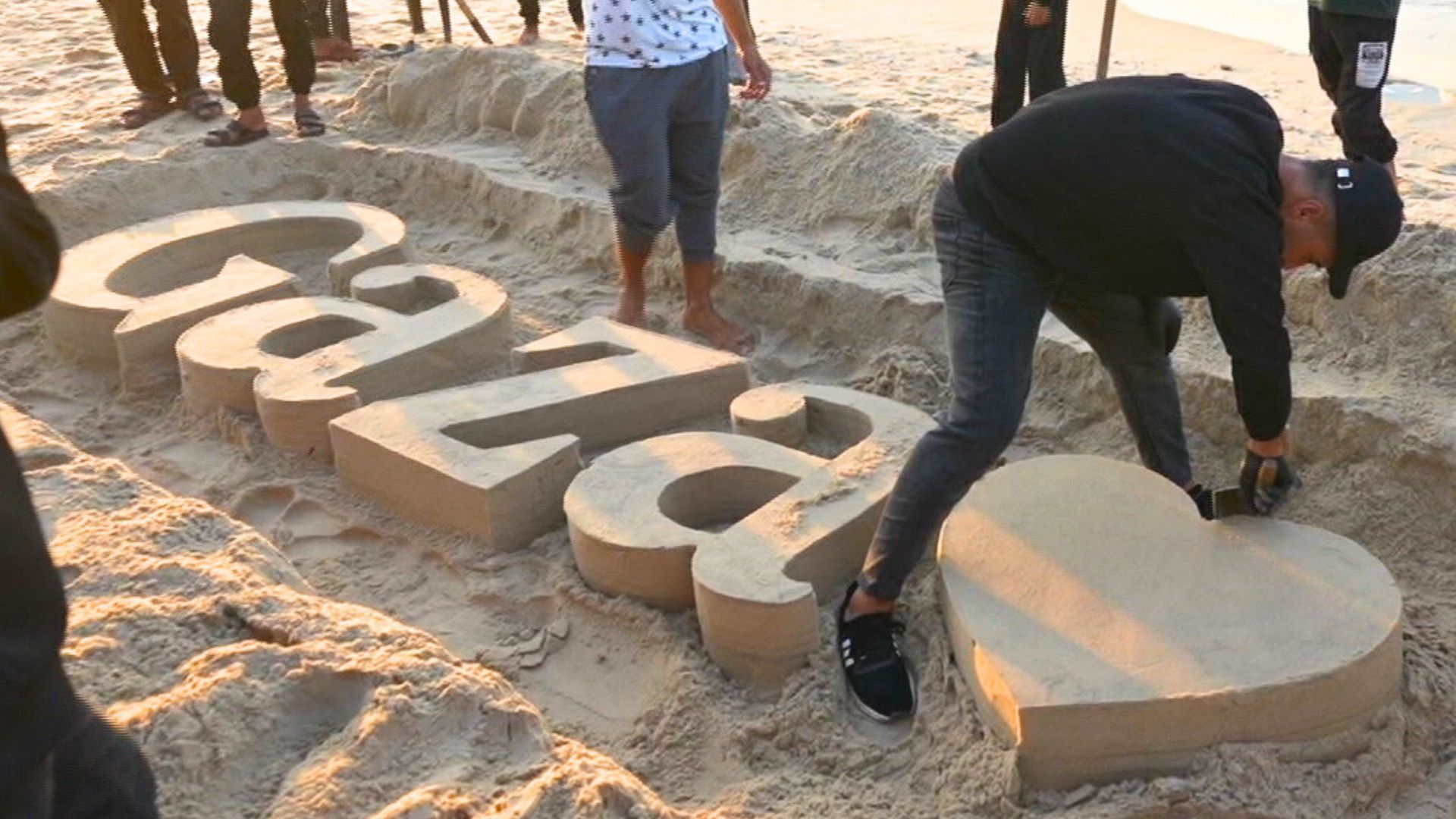 Palestinian sculptors create art on Gaza beach sand to escape Israel’s war