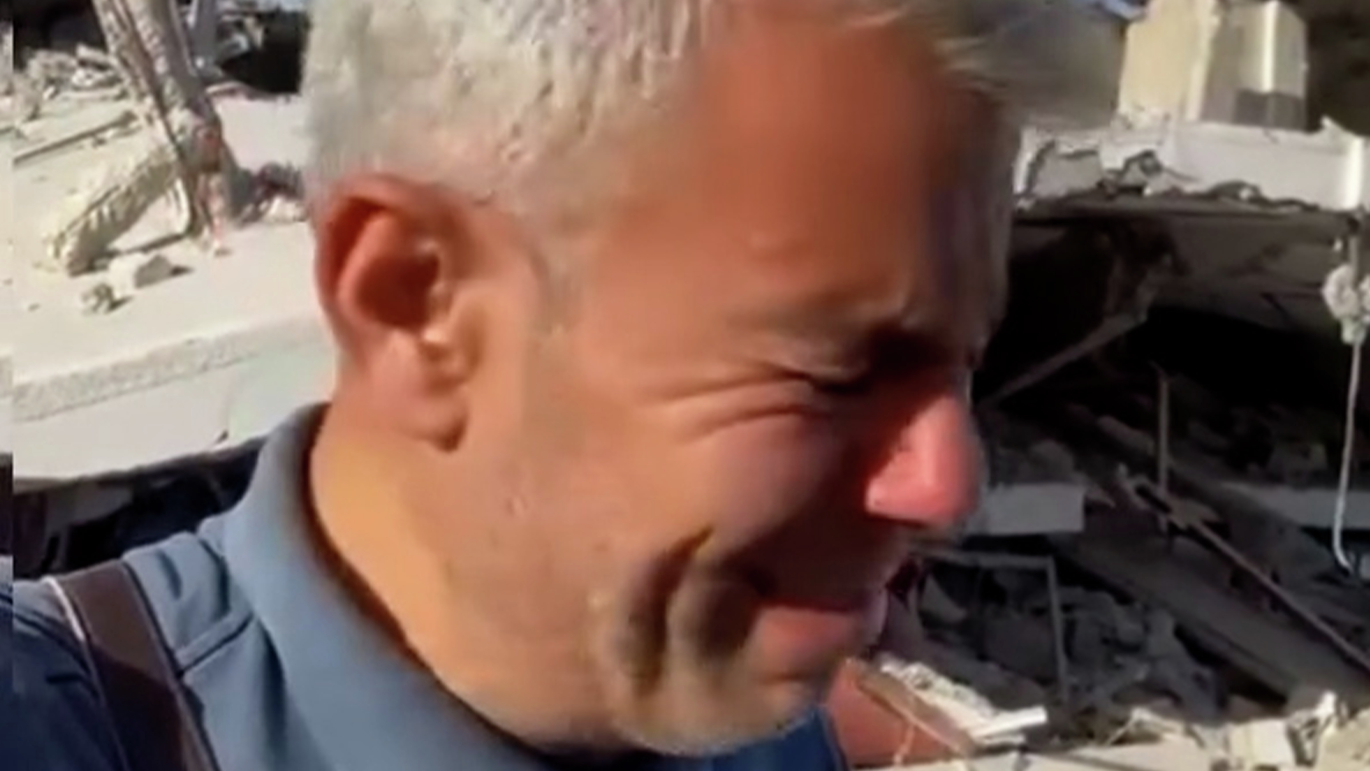 Palestinian journalist cries over ruins of destroyed home